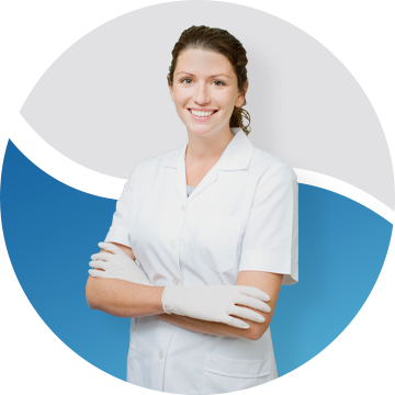 Female dentist wearing all white and smiling with her arms folded