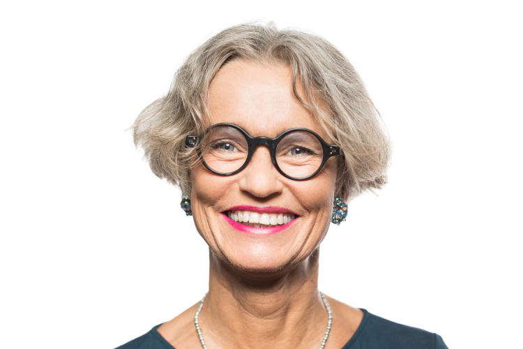 Smiling older woman with nice skin, round glasses and red lipstick