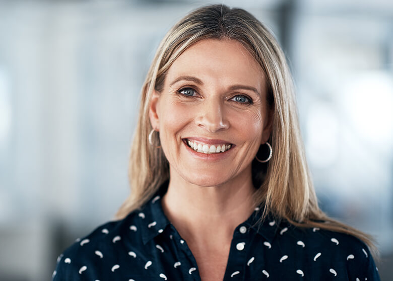 blonde woman smiling with hoop earrings