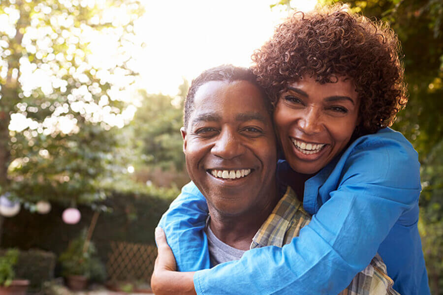 husband and wife hugging and smiling