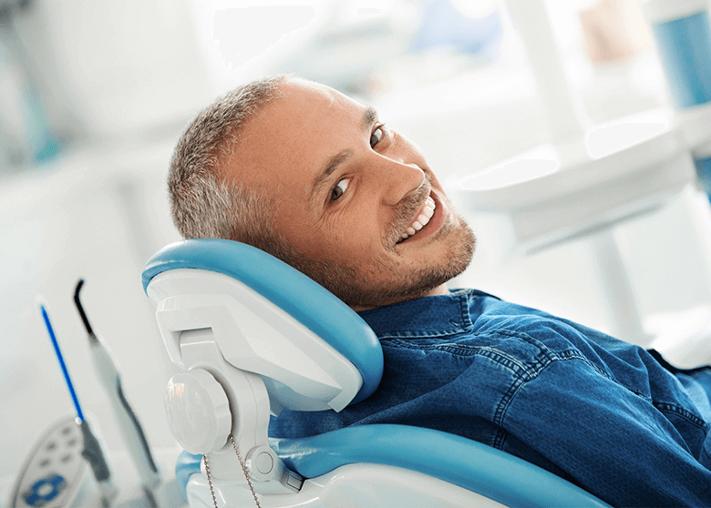 Smiling man in dental chair